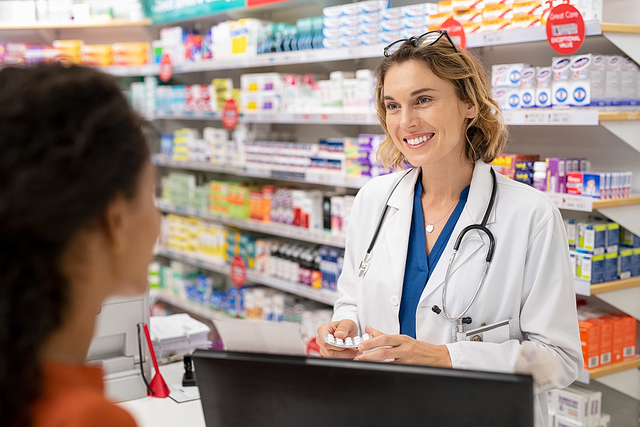 Pharmacy owner shaking hands with a Meritus Group Business Brokerage expert, symbolizing a successful pharmacy sale.